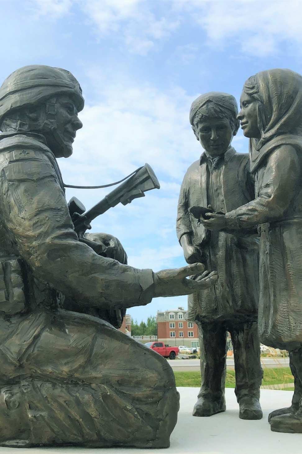 Sculpture of solider with two children
